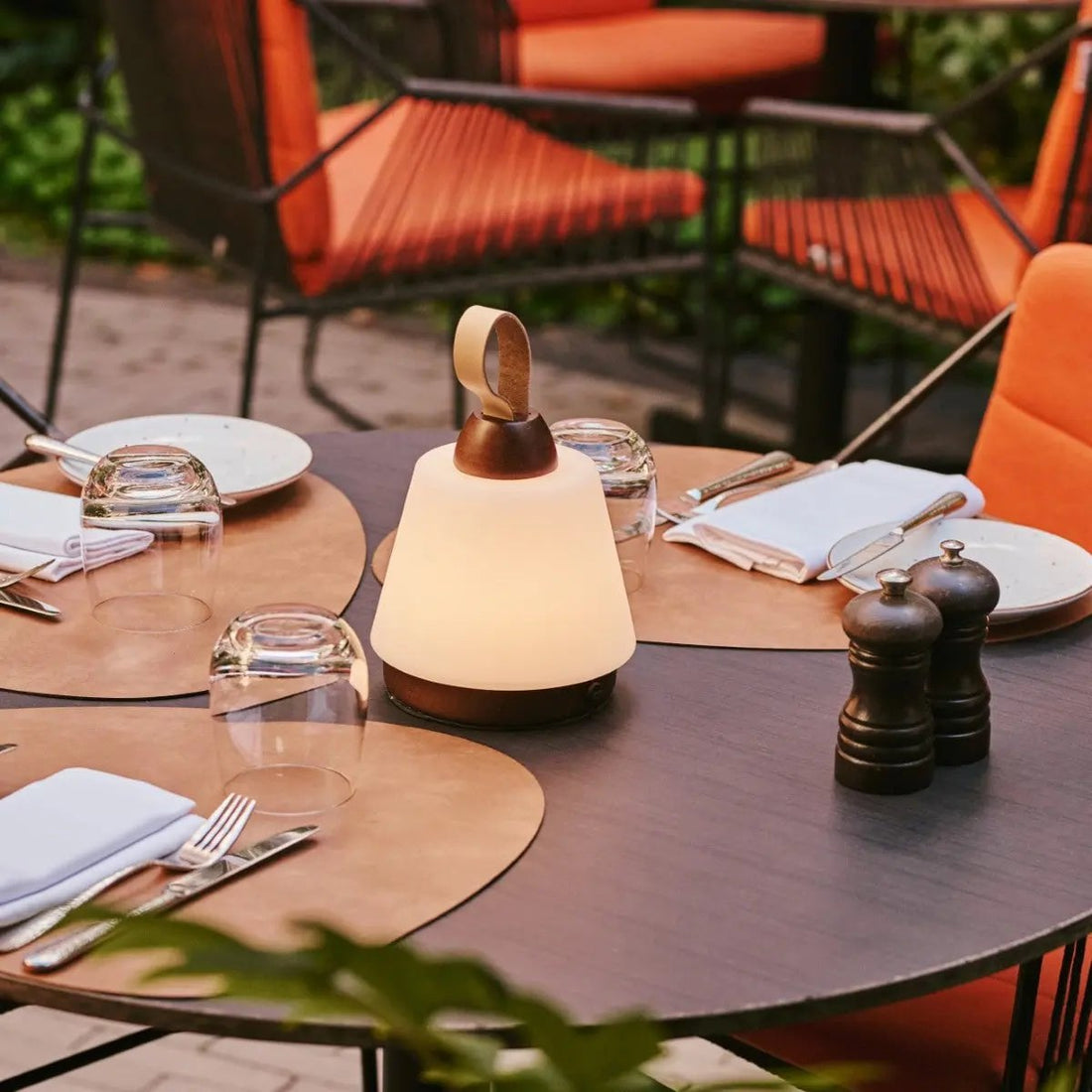 Cordless wooden table lamp on an outdoor dining table set for spring
