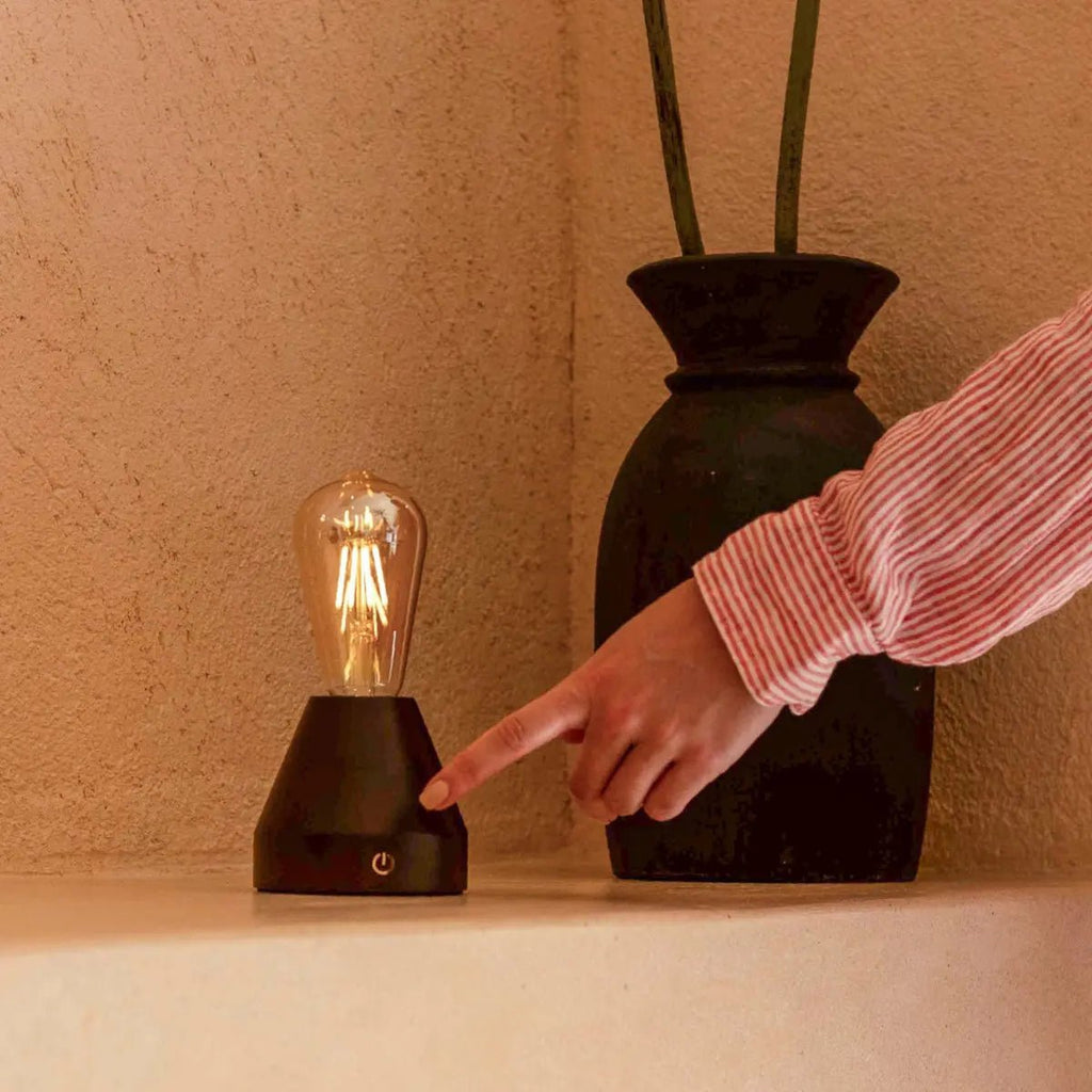Zavi dark wood lamp on bedside table