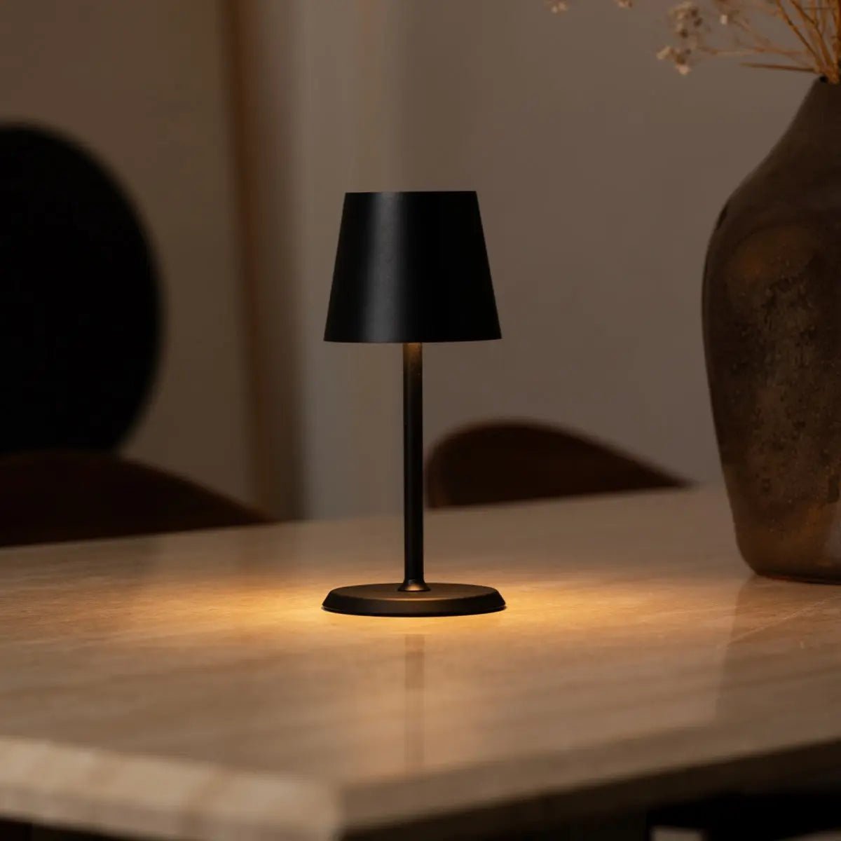Luca metal lamp side view showing cylindrical matte black form