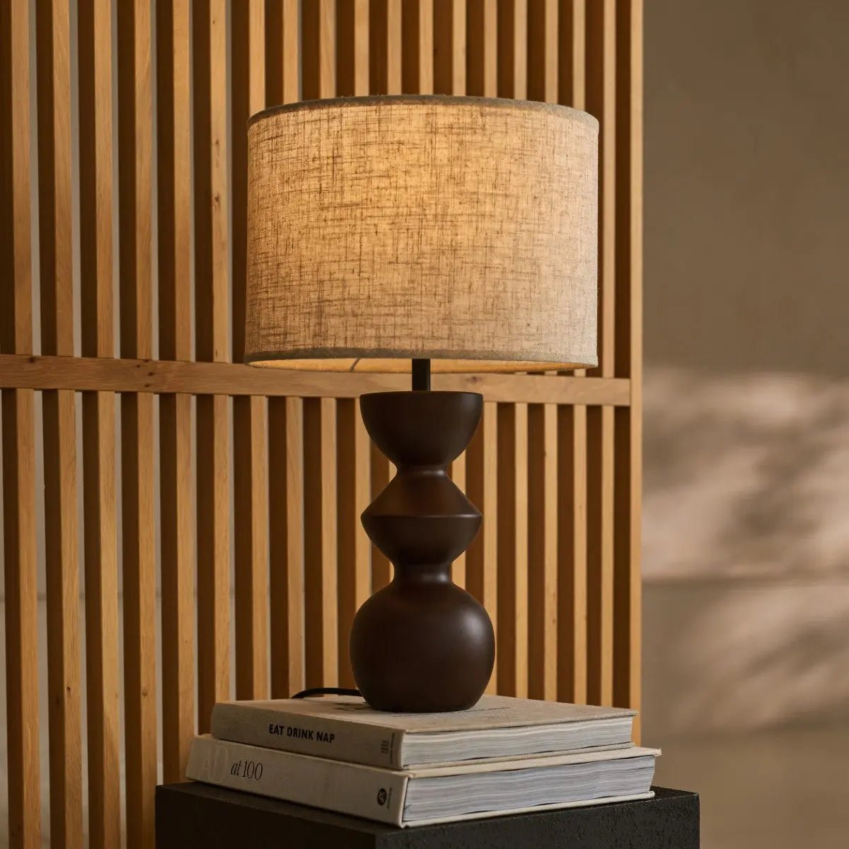 Miro corded lamp side view showing dark wood base and rounded form