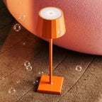 Wouter blossom orange metal lamp at full brightness