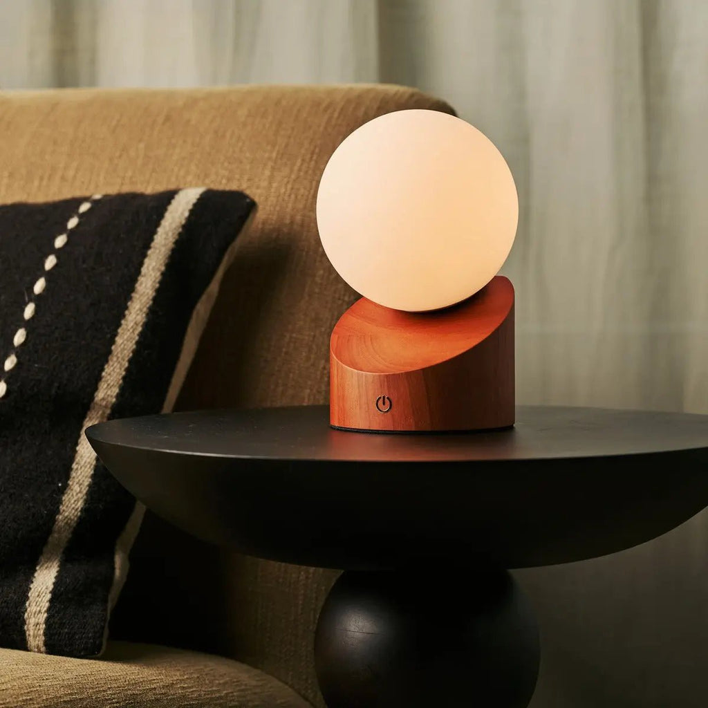 Morris cordless lamp side view showing rubberwood base and glass shade