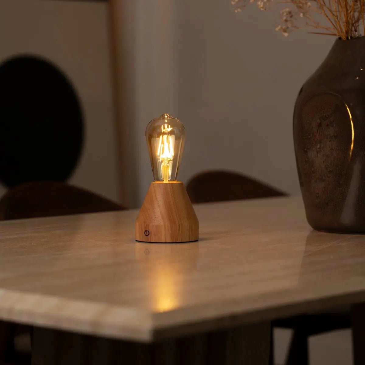 Zavi cordless lamp side view showing rubberwood base and glass shade