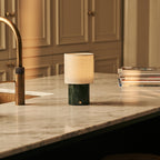 Dou marble lamp side view showing green stone base and linen shade