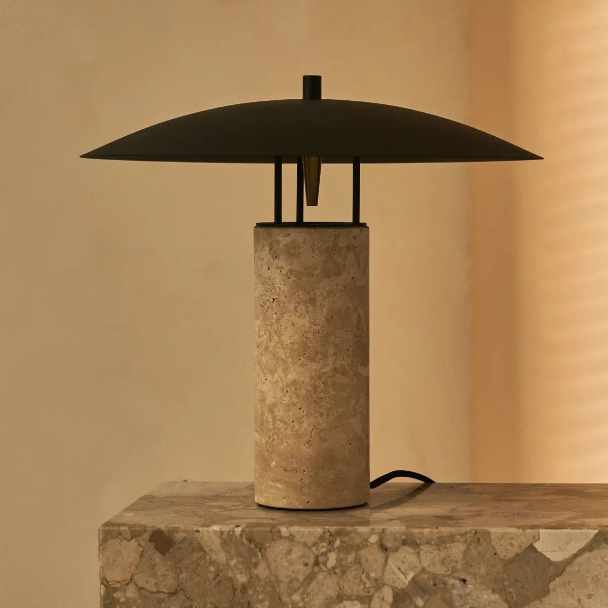 Mavro corded lamp side view showing travertine base and metal shade
