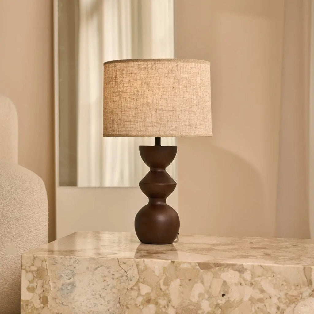 Kai dark wood lamp close-up of sand shade warm light