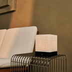 Zano cordless lamp side view showing black rubberwood and linen shade