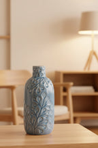 Decorative ceramic vase with leaf patterns on a white background