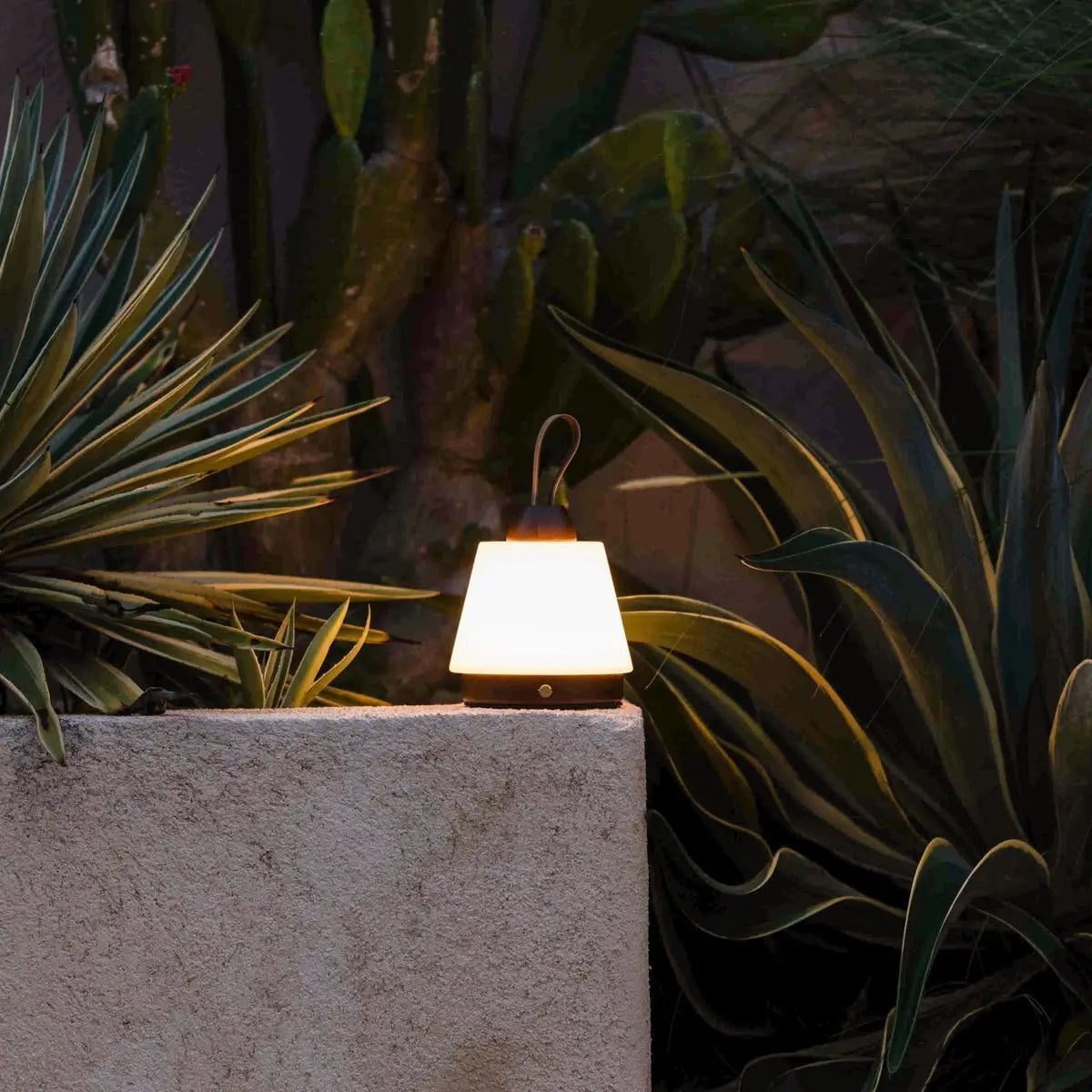 Amber cordless lamp in bedroom on bedside table