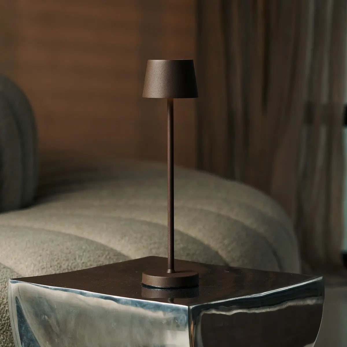 Vondel cordless lamp glowing warm ambient light on table