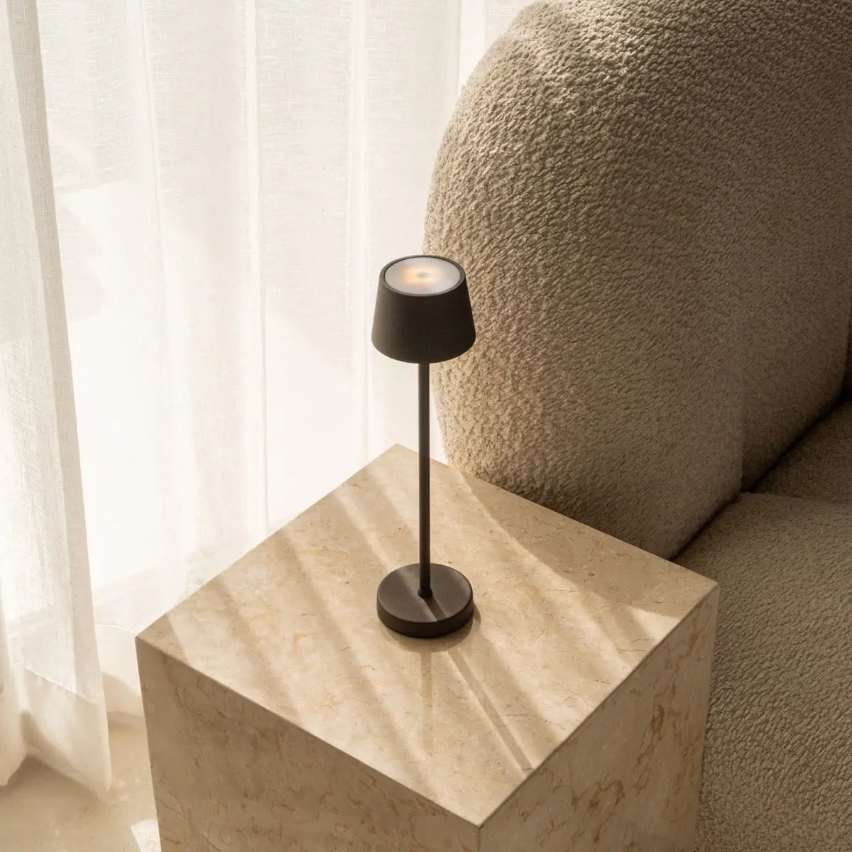 Vondel rechargeable lamp on dining table with warm candlelight mode