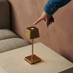 Sarphati cordless lamp glowing warm ambient light on table