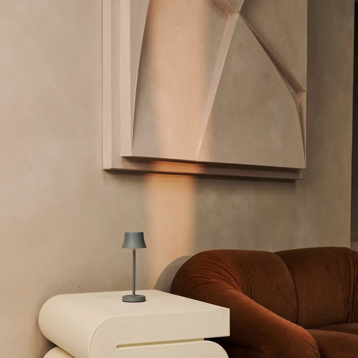 De Pijp cordless lamp glowing warm ambient light on table