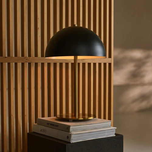 Lola corded lamp side view showing black and gold metal form