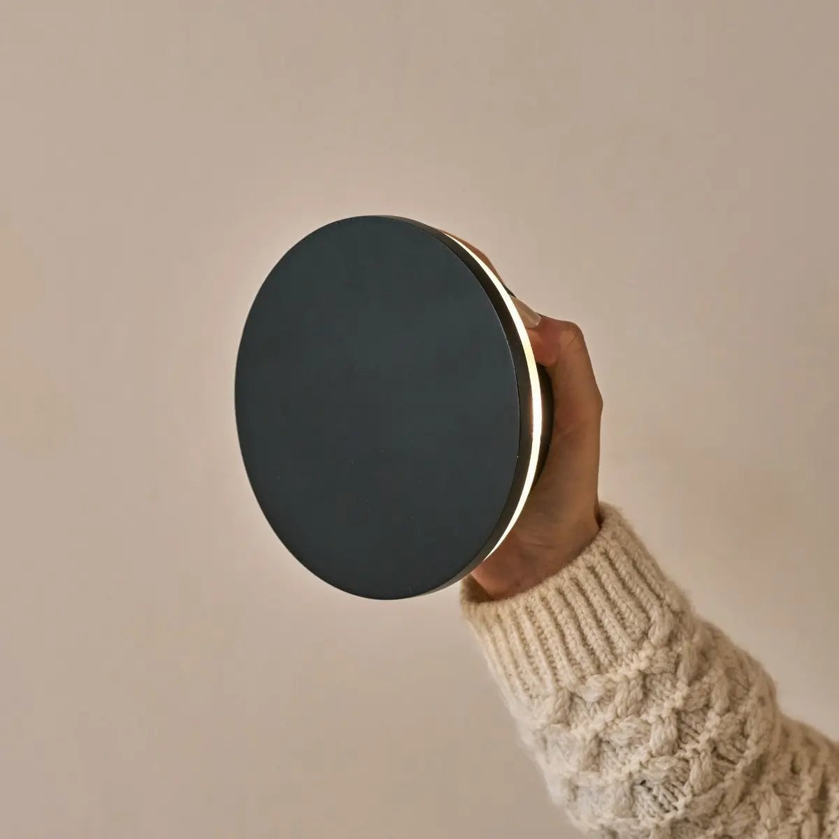 Lou black wall lamp side view showing matte black form