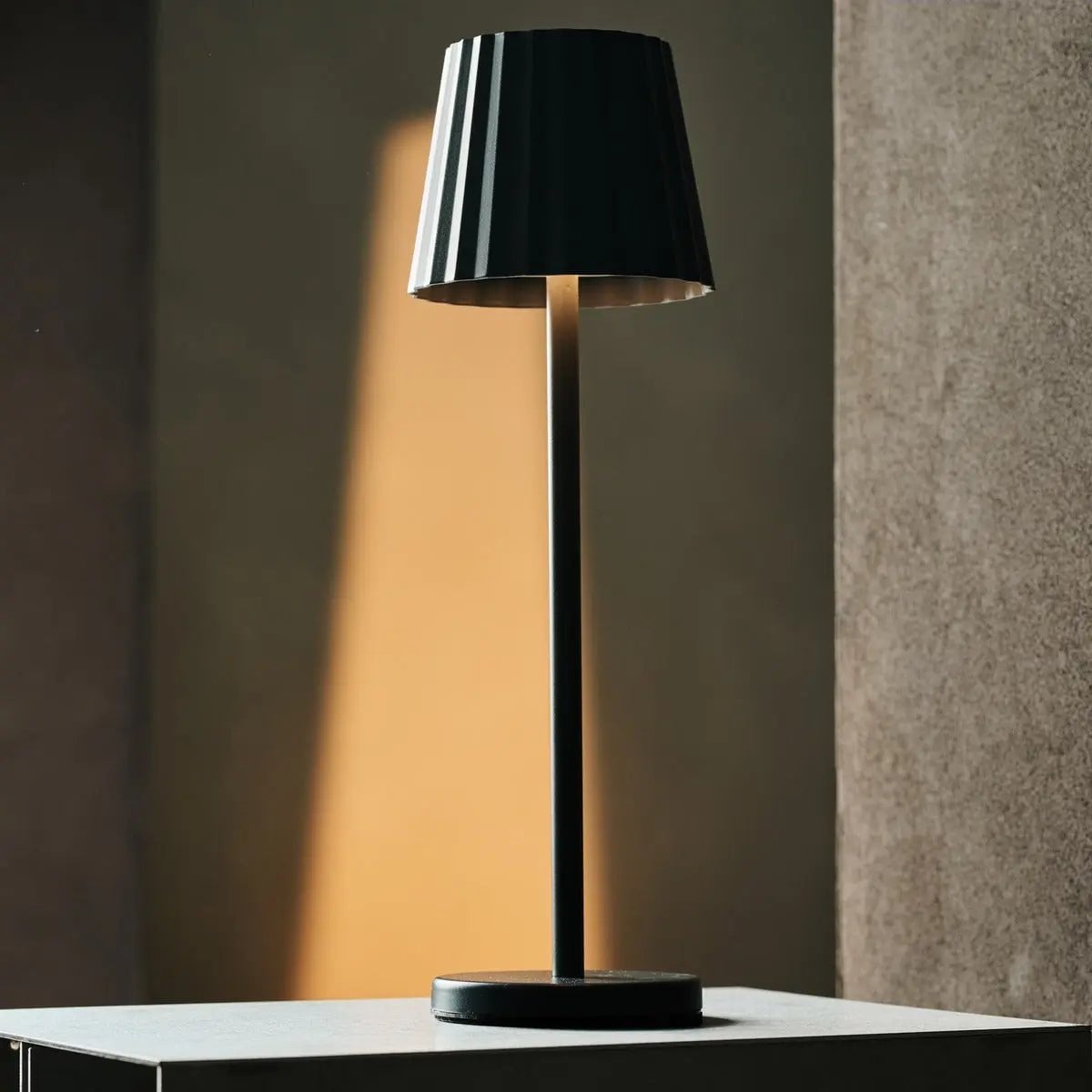 Keva metal lamp side view showing cylindrical stone grey form