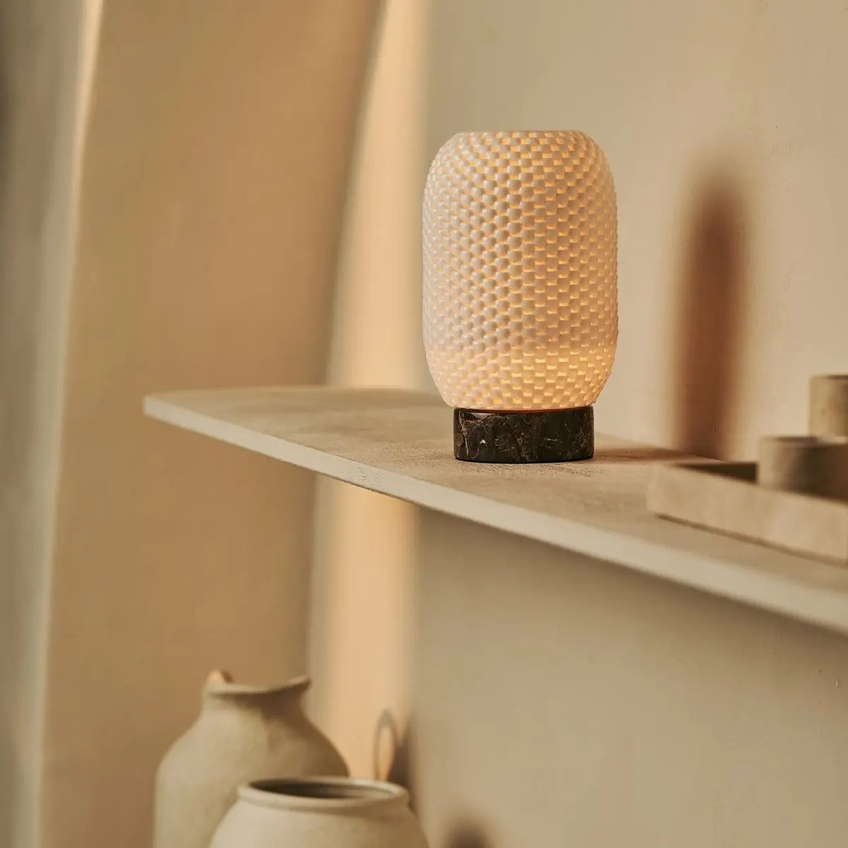 Aurora marble lamp side view showing dark stone and porcelain shade