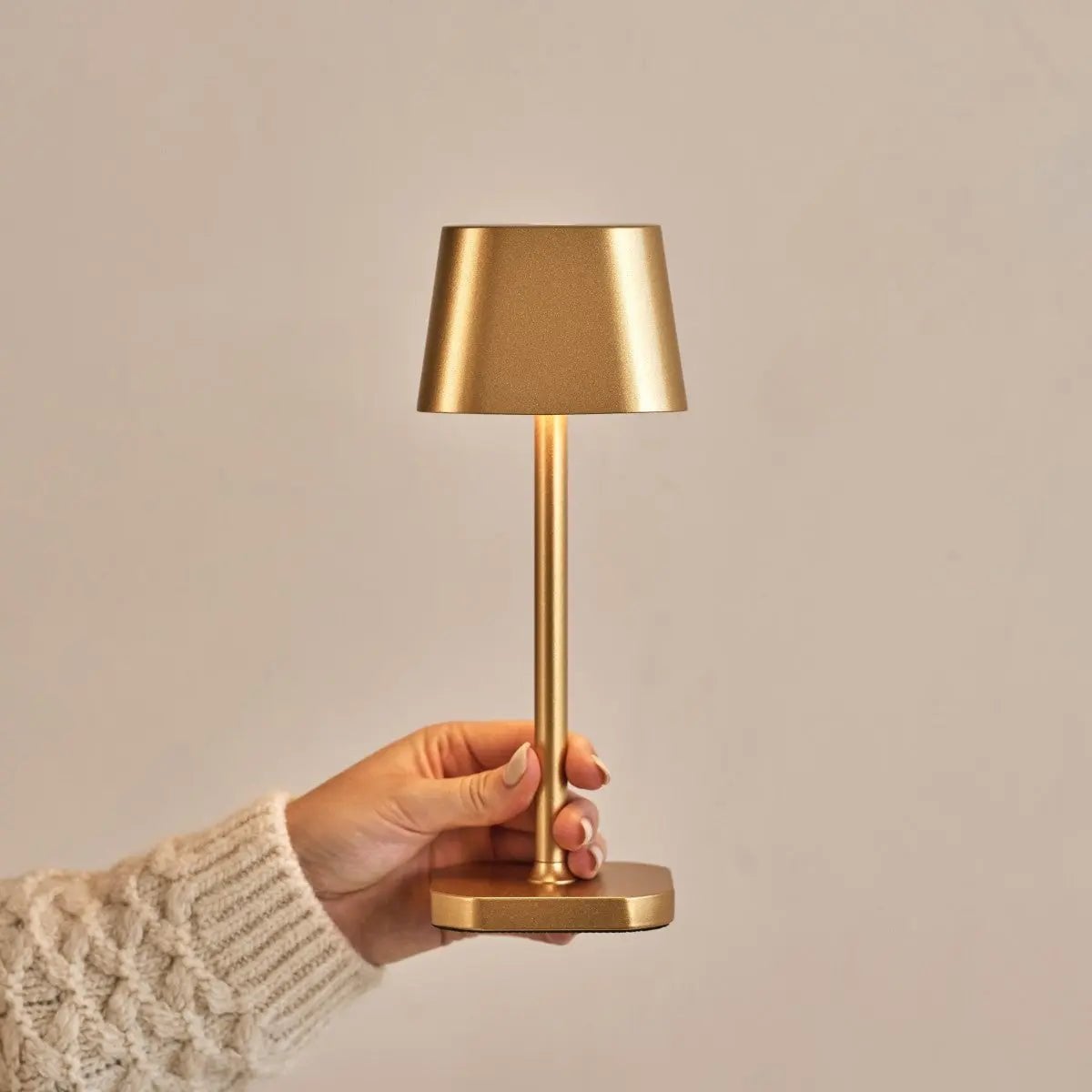 Riva metal lamp side view showing cylindrical gold form