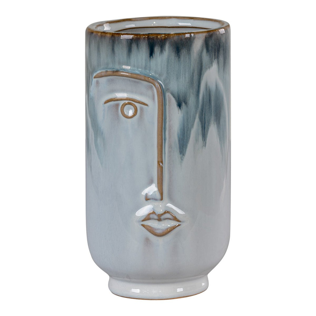 Faces porcelain vase with fresh flowers on shelf