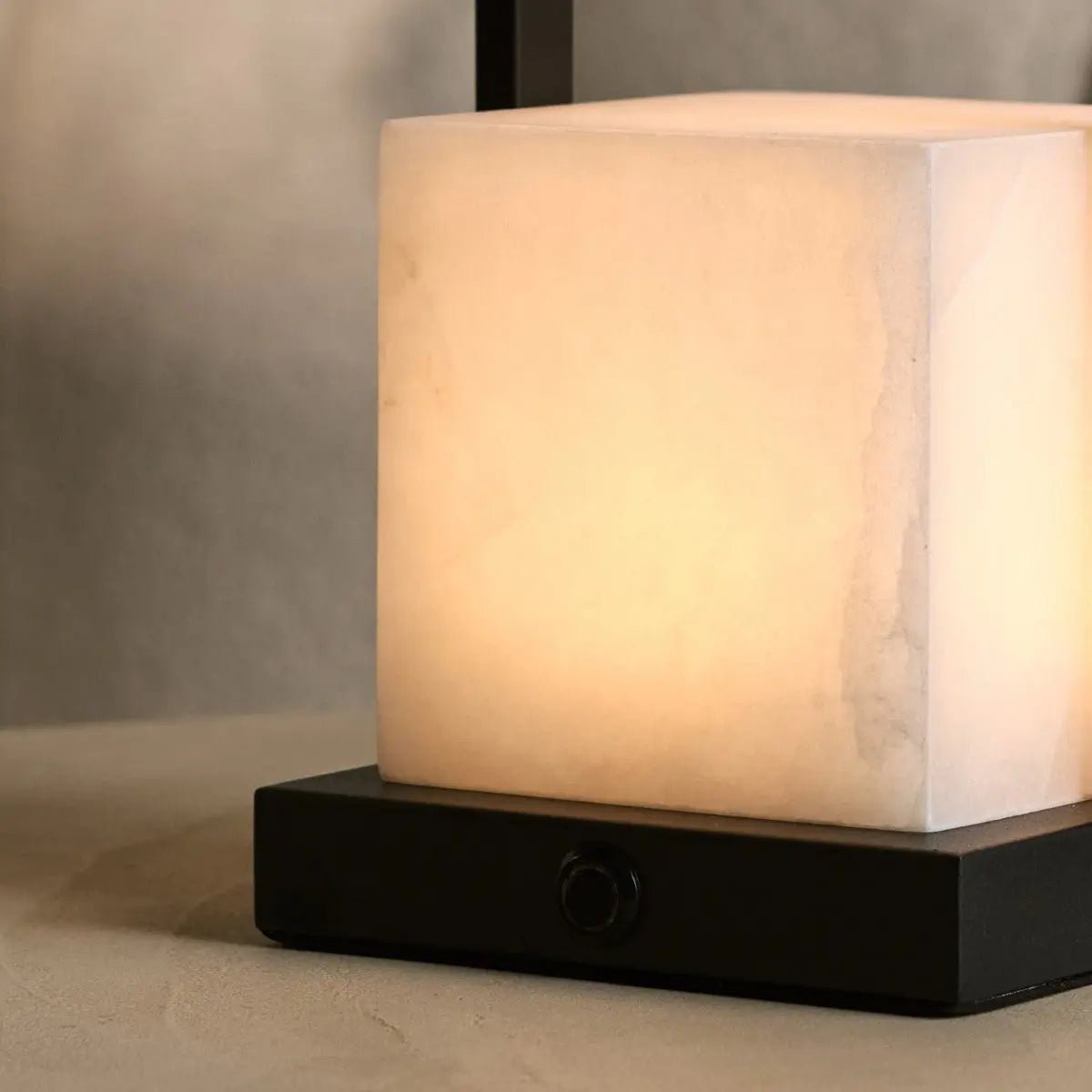 Alvara cordless lamp side view showing metal base and alabaster shade