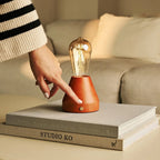 Zavi cordless lamp side view showing rubberwood base and glass