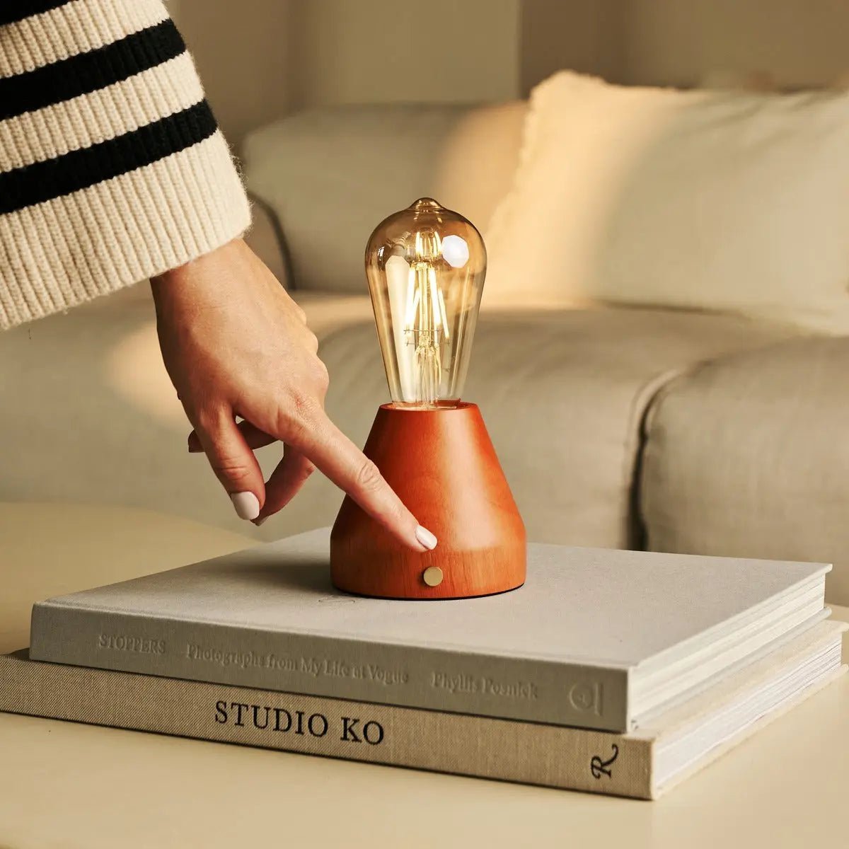 Zavi cordless lamp side view showing rubberwood base and glass