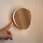 Lulu wood wall lamp overhead view showing compact round form