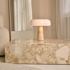 Emily corded lamp side view showing travertine base and glass shade