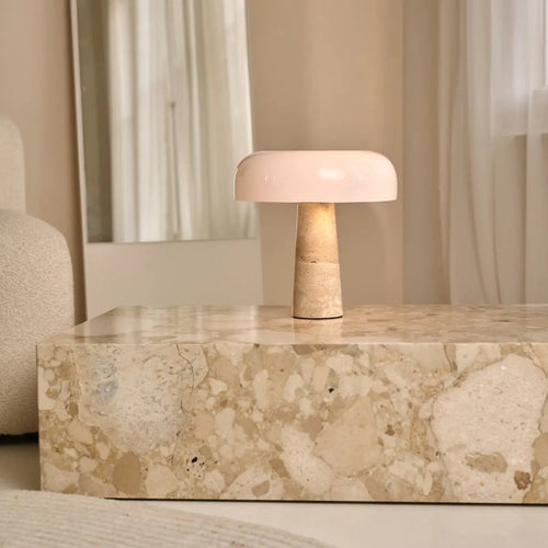 Emily corded lamp side view showing travertine base and glass shade