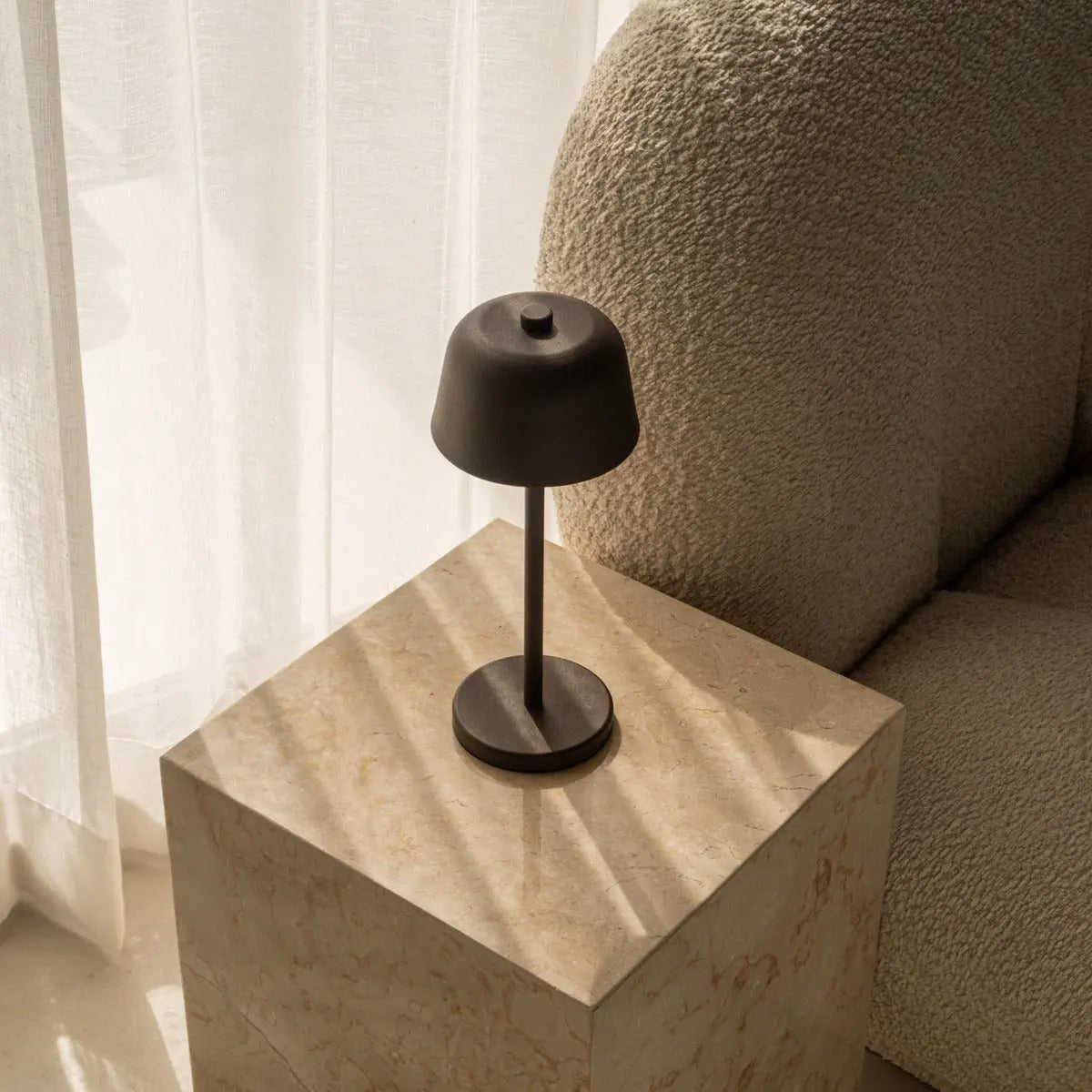 Dael metal lamp side view showing cylindrical mocha brown form