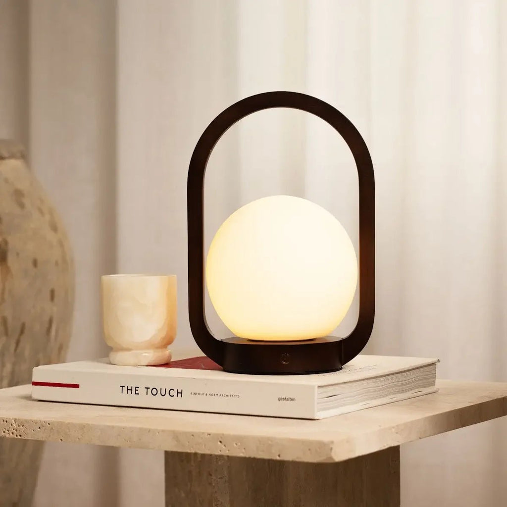 Skye cordless lamp side view showing dark rubberwood base and linen shade
