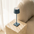 Wouter cordless lamp on dining table in ambient light mode