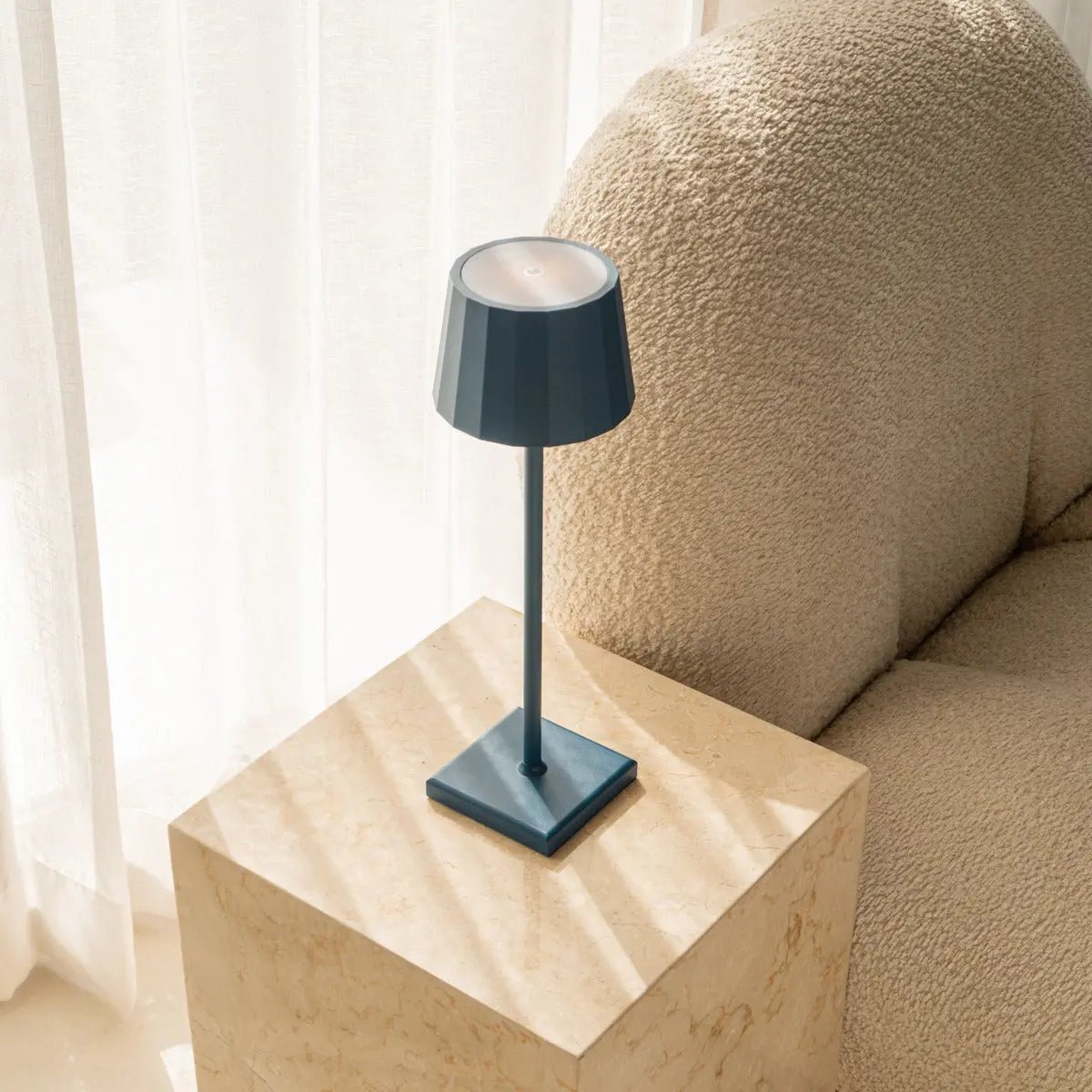 Wouter cordless lamp on dining table in ambient light mode