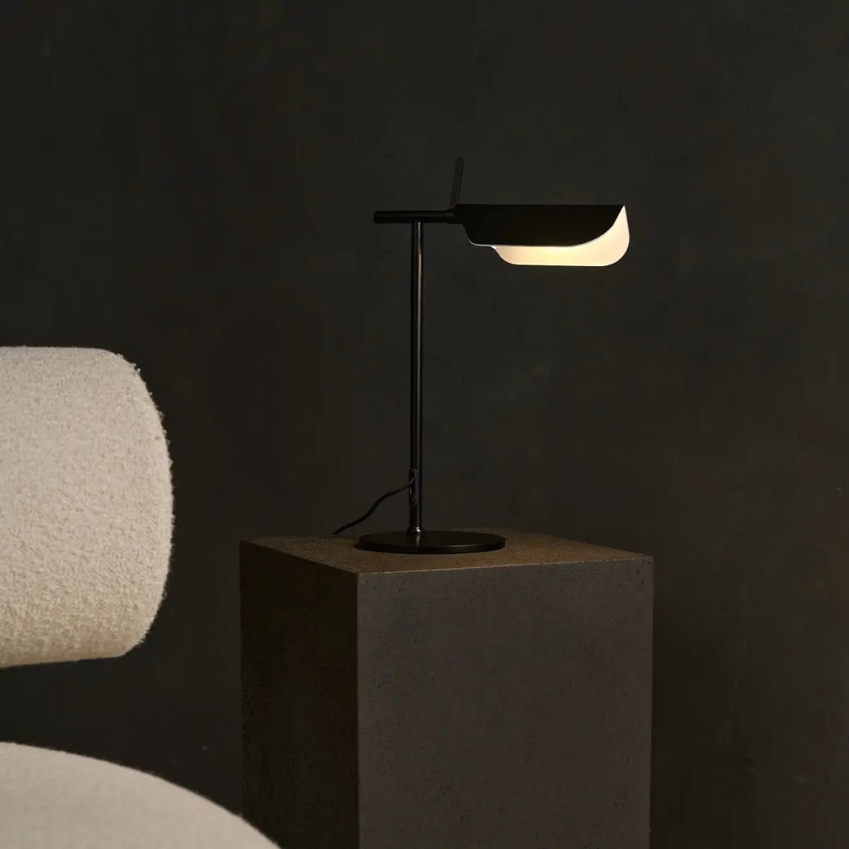 Halen corded lamp side view showing travertine base and metal body