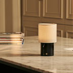 Dou black marble lamp side view showing dark stone base