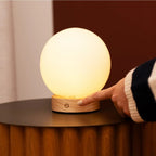Flore cordless lamp side view showing rubberwood and matte glass shade