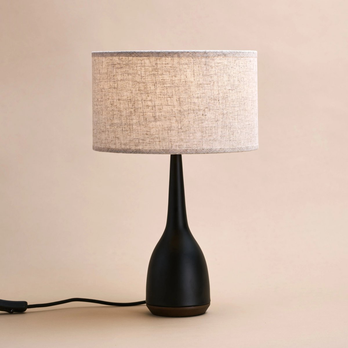 Navo corded lamp side view showing black rubberwood base