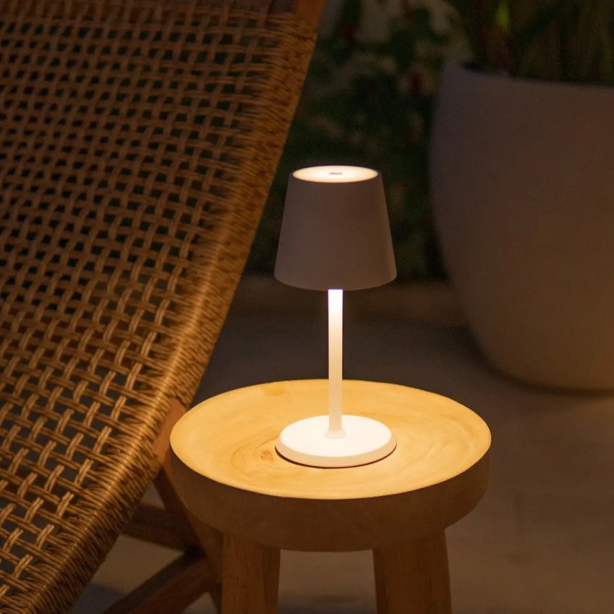 Pavo rechargeable lamp warm ambient glow on bedside table
