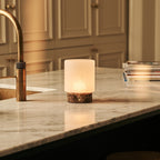Cuyp marble lamp side view showing dark stone base
