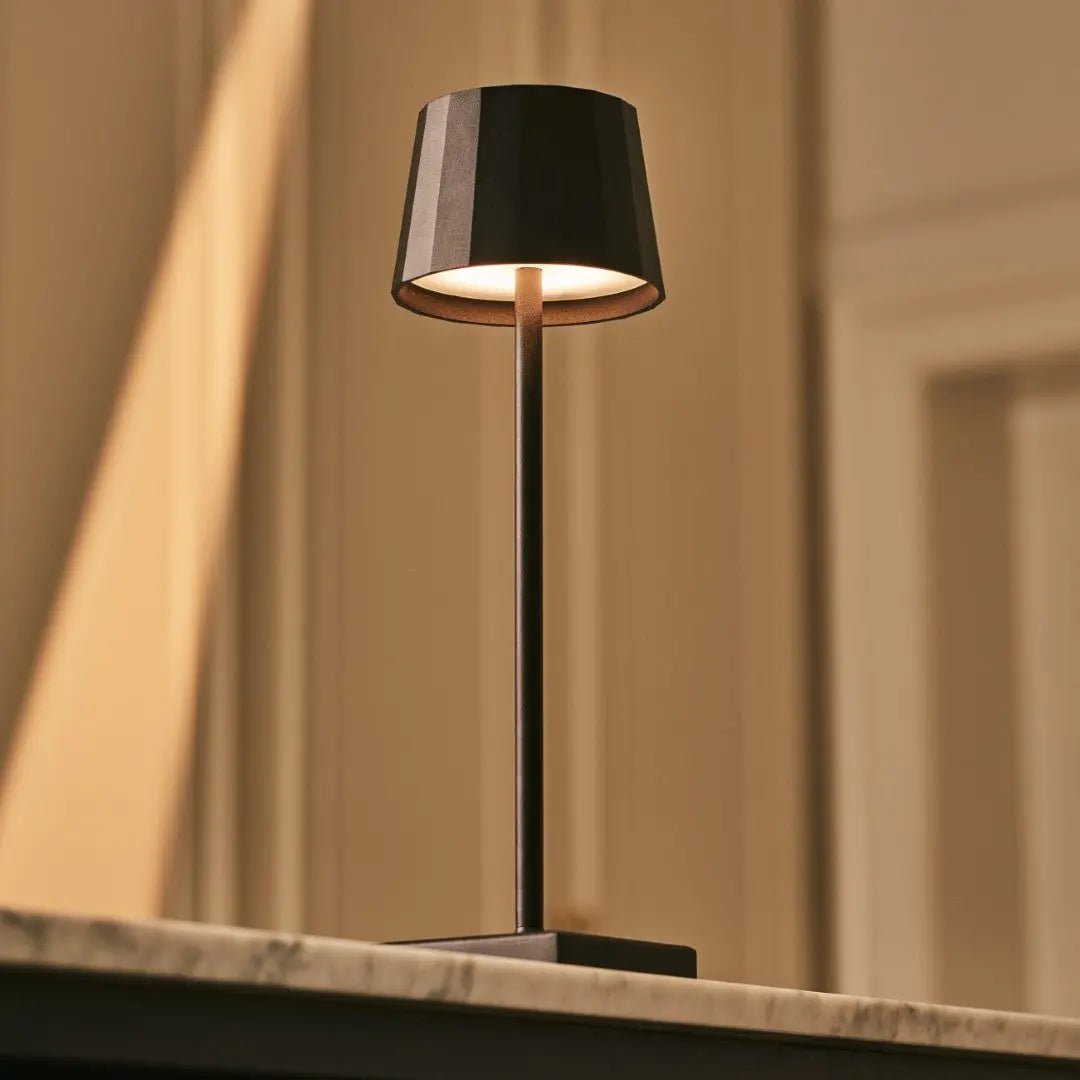 Nael metal lamp side view showing cylindrical matte black form