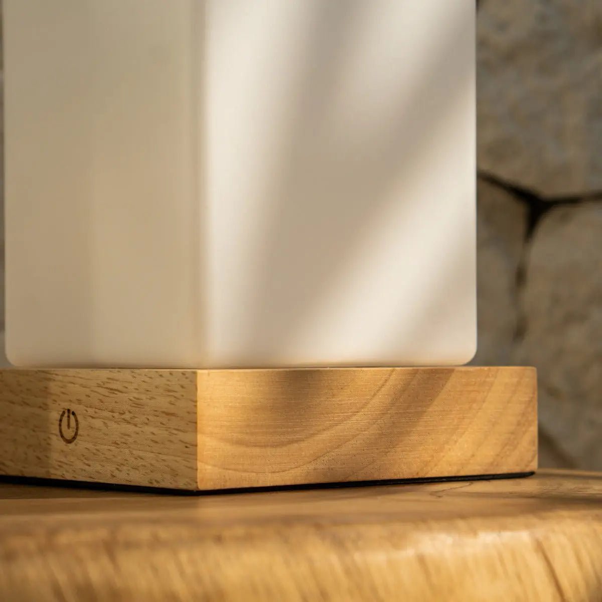Zayn cordless lamp side view showing rubberwood base and glass shade