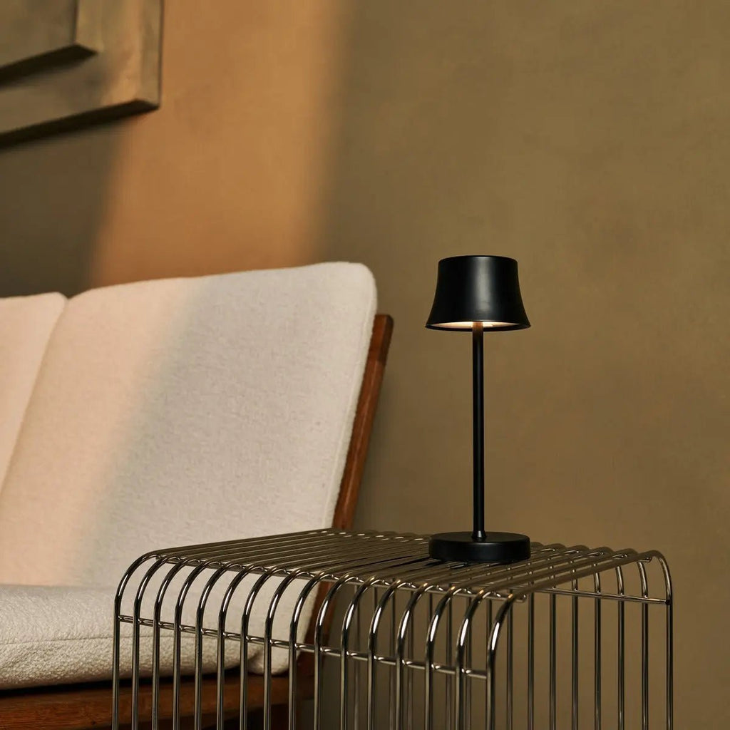 De Pijp midnight black lamp glowing on restaurant table