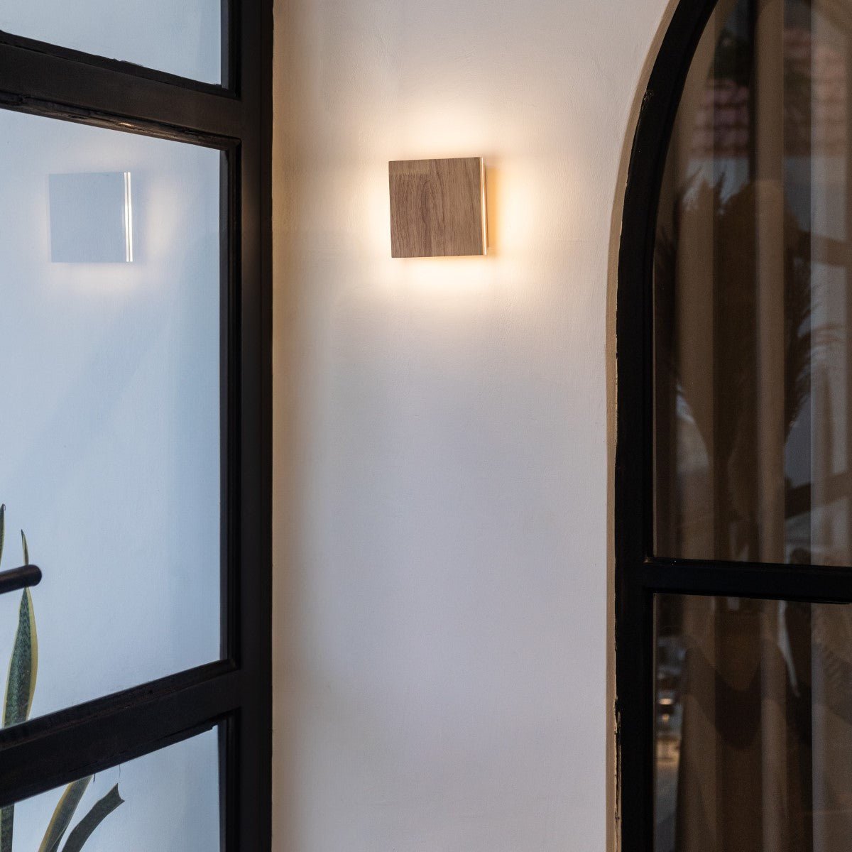 Lane rechargeable wall lamp mounted in hallway setting