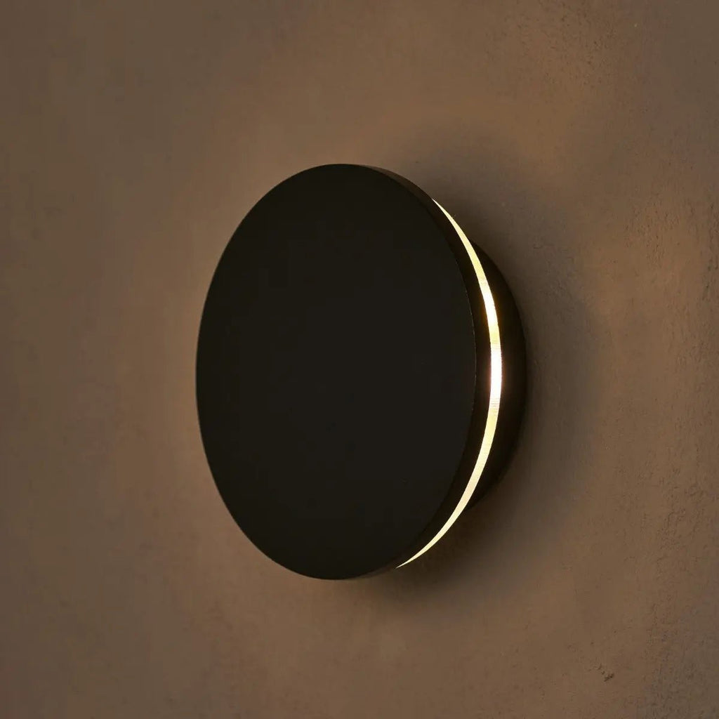 Lou cordless wall lamp mounted in hallway setting