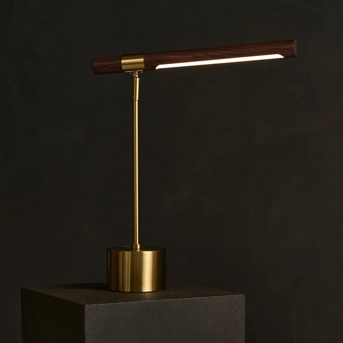 Elara gold lamp side view showing adjustable height metal form