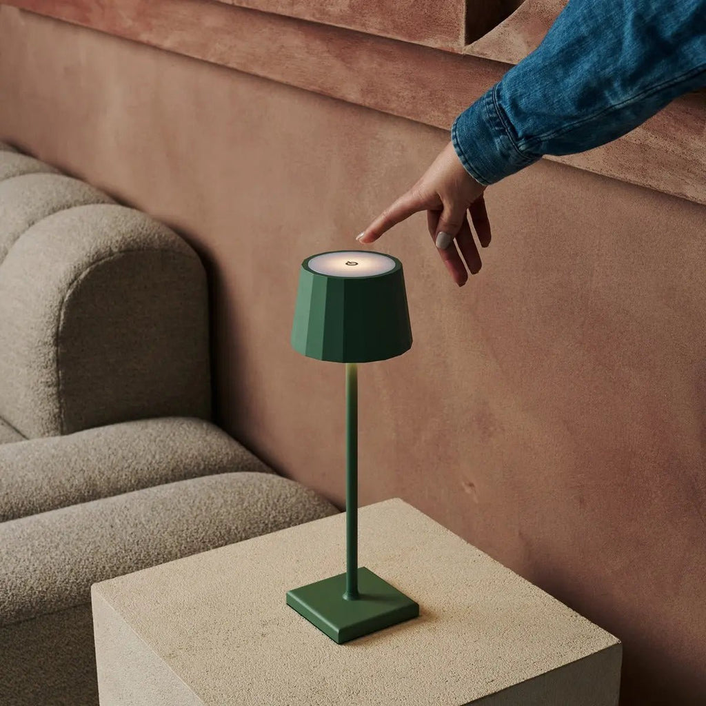 Wouter cordless lamp on dining table in ambient light mode