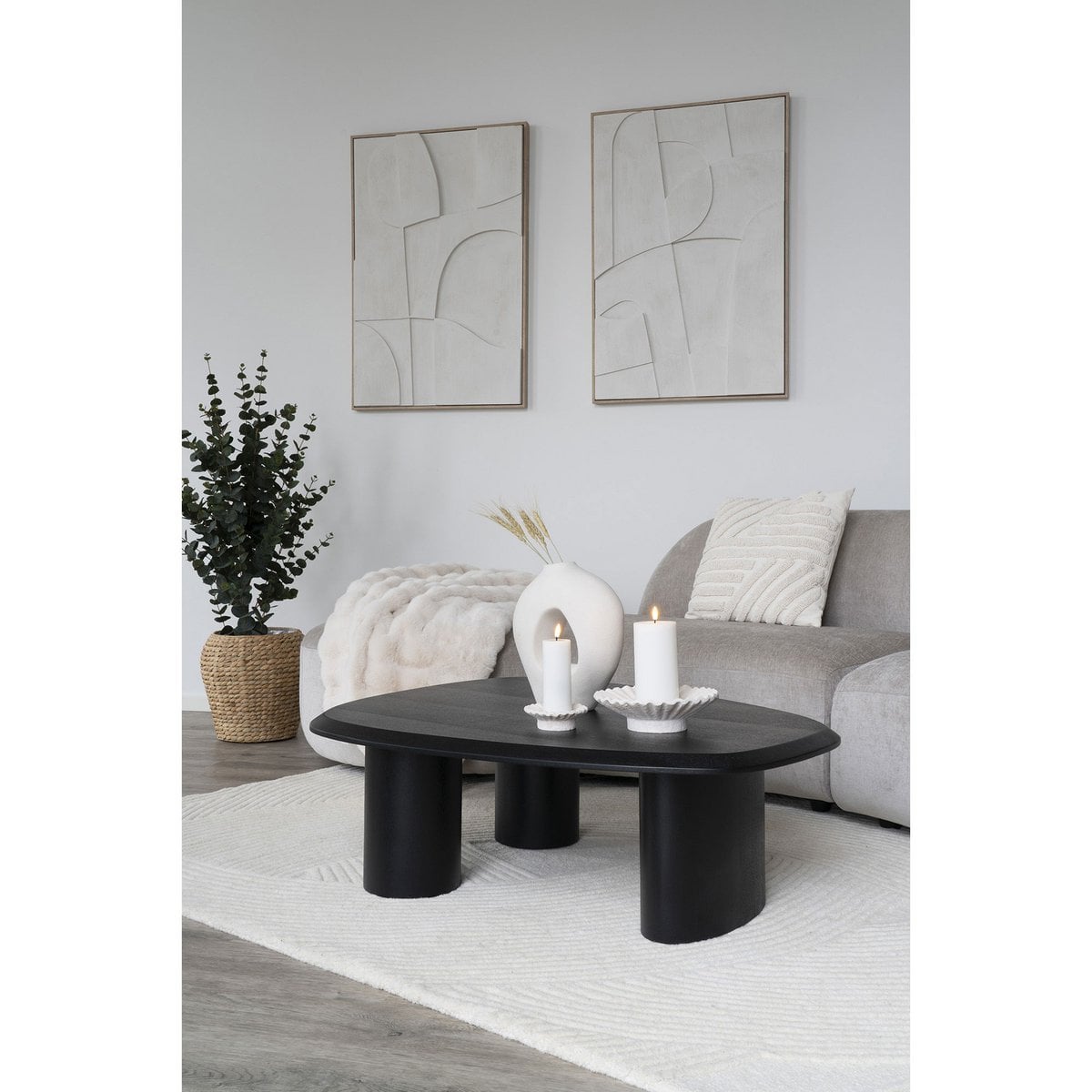 Lumira sculptural vase with single stem in living room
