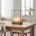 Manali antique brass metal and glass lantern styled on a Scandinavian dining table with warm candlelight