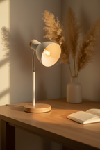 Marie white metal desk lamp with wood base on oak desk with linen notebook
