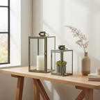 Set of two Corfu green steel glass lanterns on a sideboard in a Nordic interior with dried botanical styling